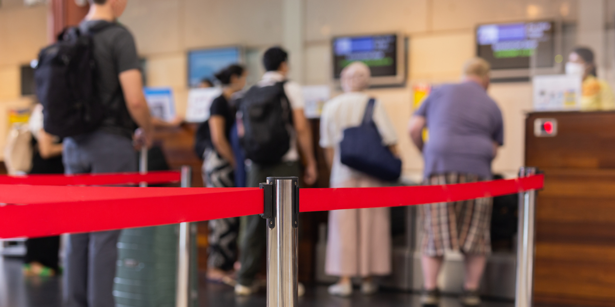 line of customers at an airport rental car counter