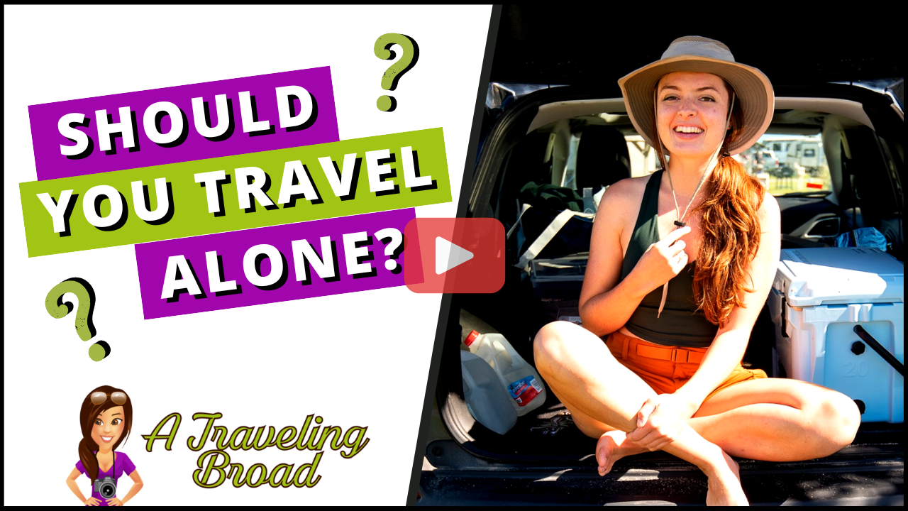 Should you travel alone? Image with a young woman sitting cross-legged in the back of her SUV