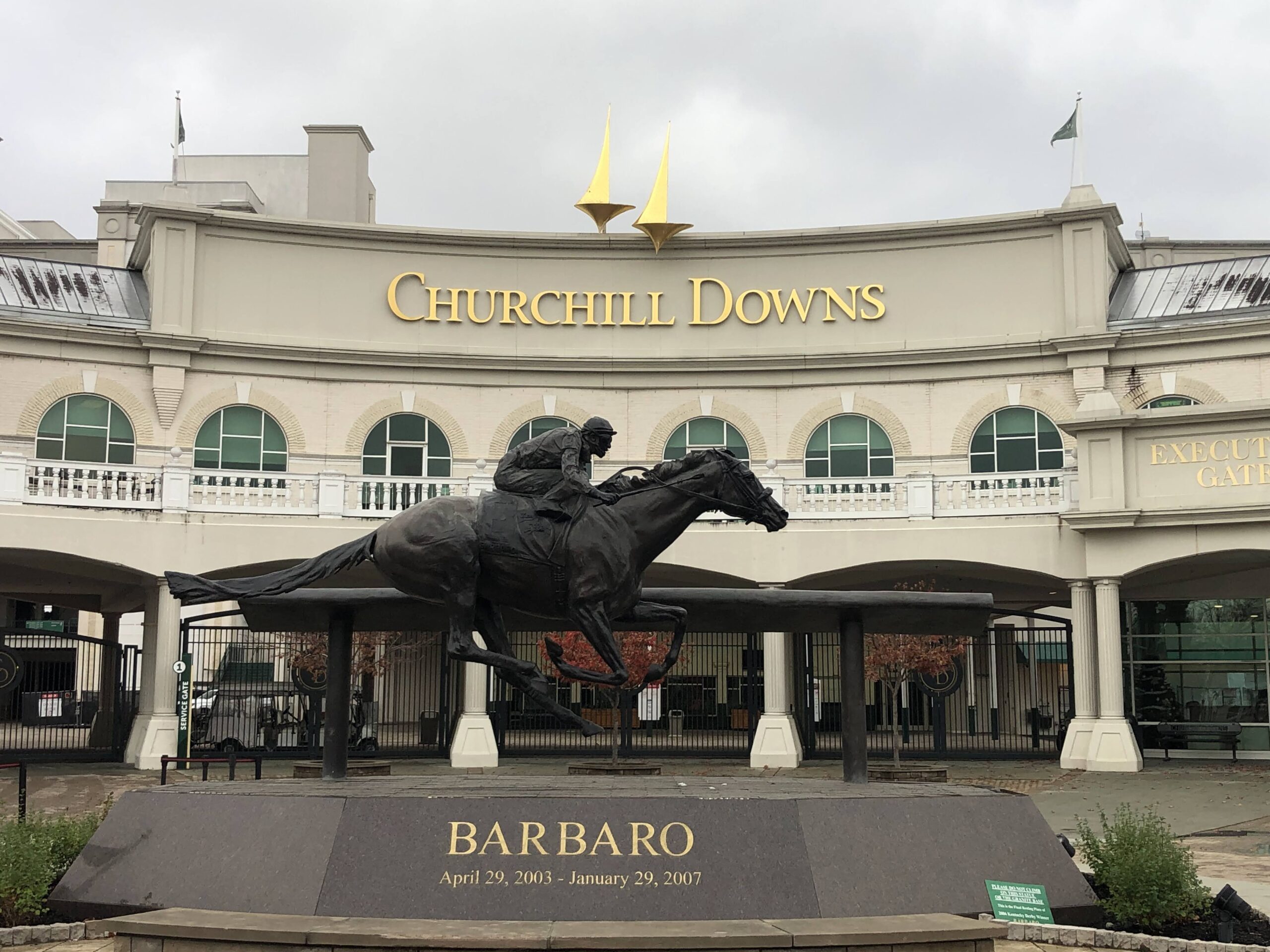 The entrance to Churchill Downs with a statue of champion horse, Barbaro, and his jockey